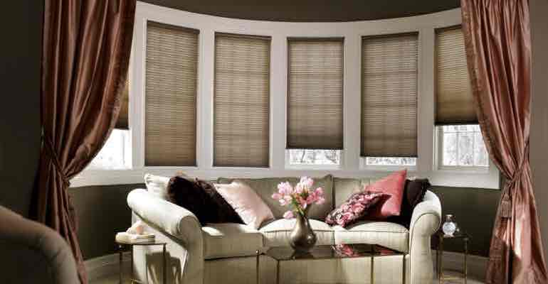 Vertical cellular shades in parlour bow window.